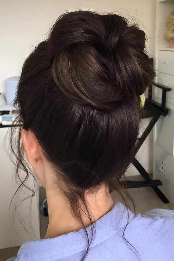 high messy bun with face-framing pieces